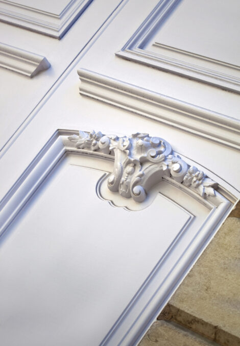 Stylish wooden door on the facade of a French mansion
